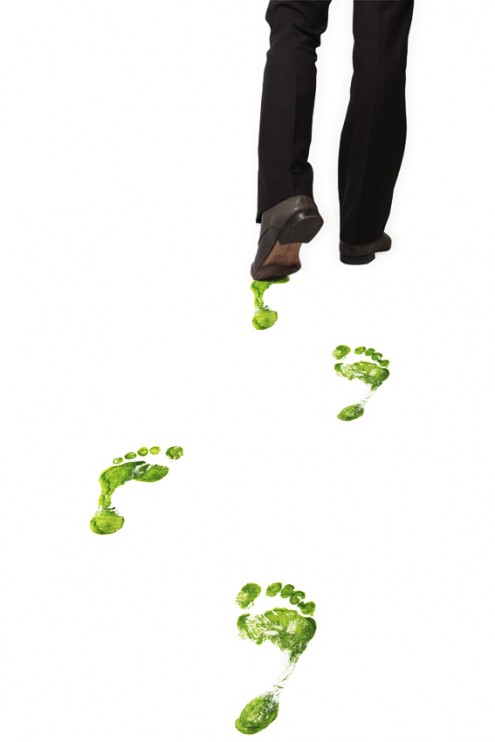 Businessman leaves green footprints